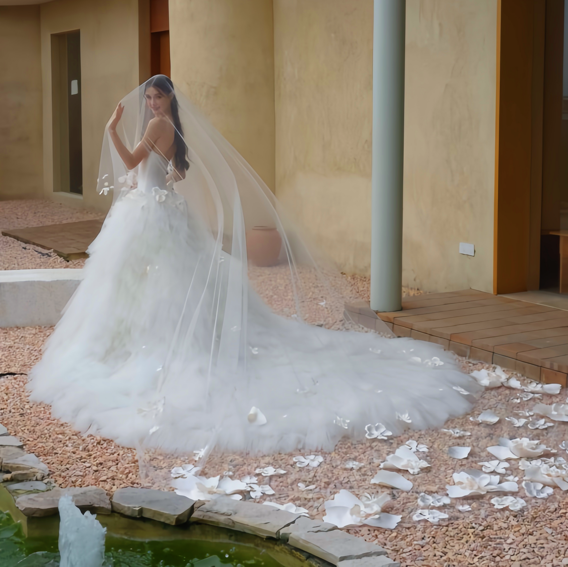 3D floral tulle ball gown wedding dress with dramatic long train and romantic bridal veil, back view