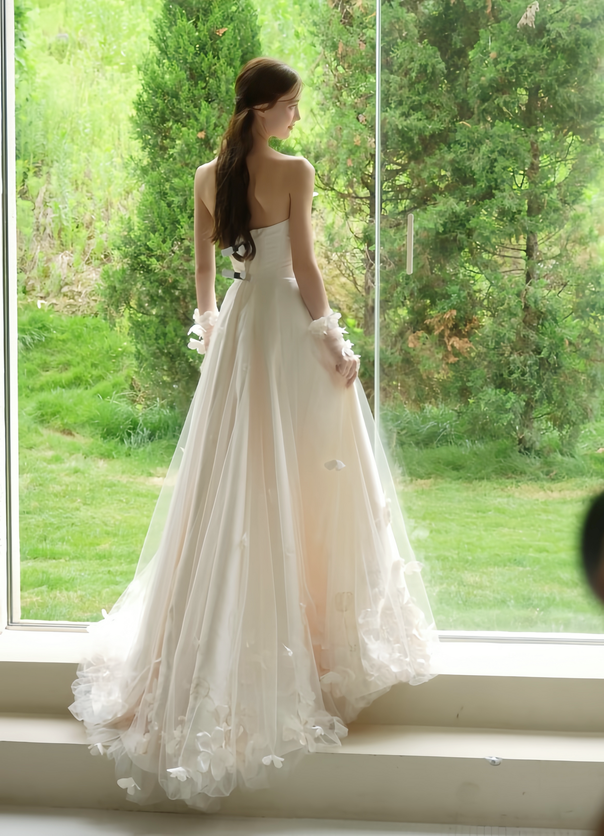 Back view of ivory floral A-line wedding dress with flowing tulle skirt, 3D appliqués and soft train