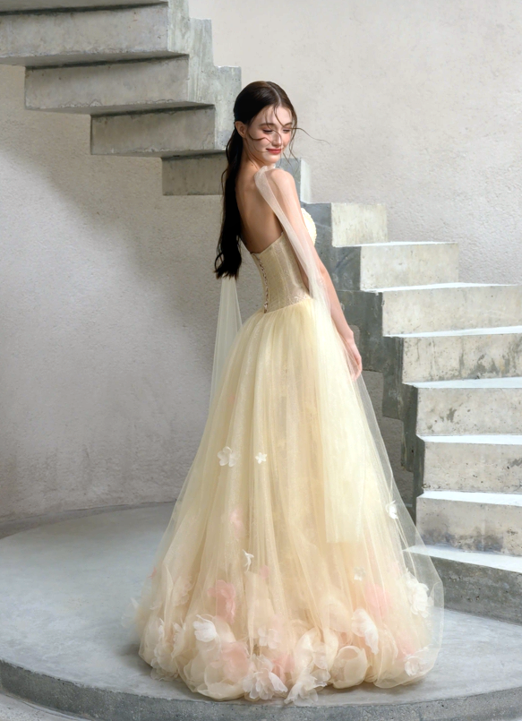 Butter yellow A-line wedding dress with open back, layered tulle skirt and romantic 3D floral appliqués