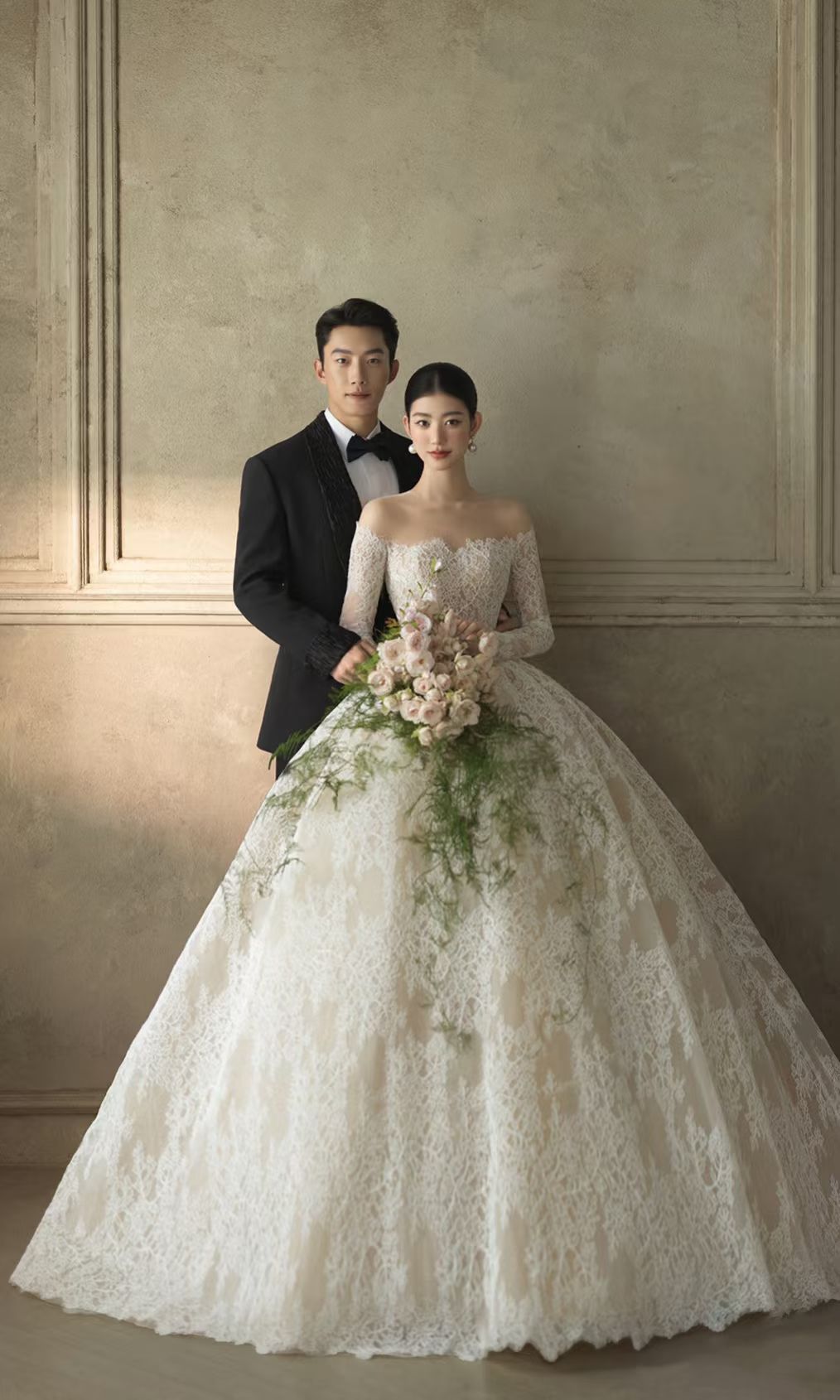Classic ivory lace ball gown wedding dress with off-the-shoulder neckline, long sleeves and full princess skirt