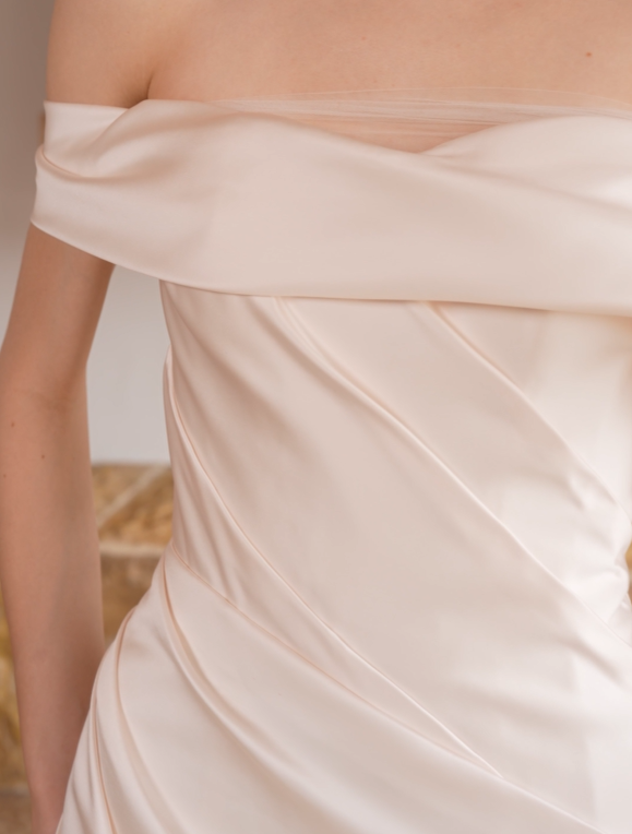 Draped satin bodice and off-the-shoulder neckline on a minimalist wedding dress