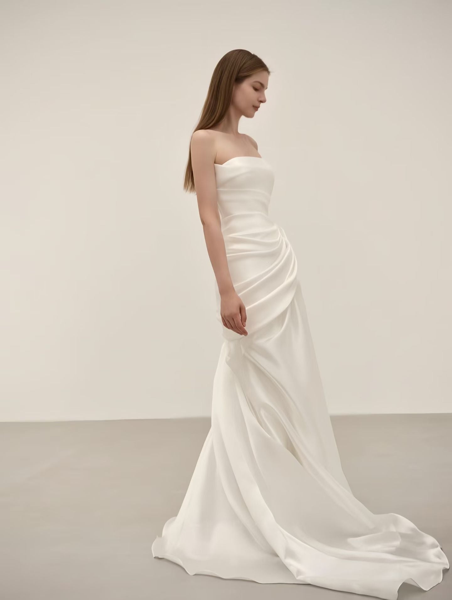 Flowing satin mermaid skirt and sweep train on a minimalist wedding dress