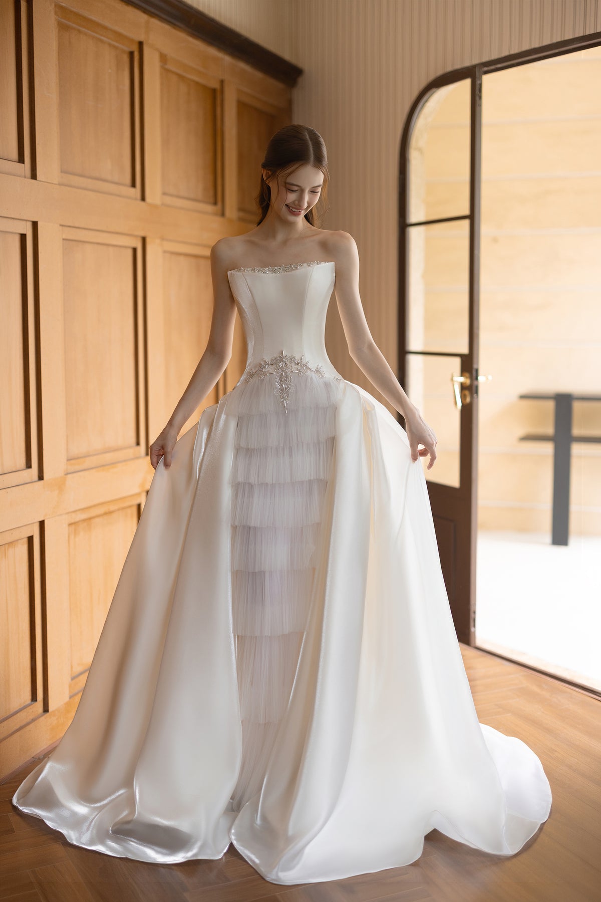 Ivory satin Basque waist wedding dress with crystal beading, layered tulle panel and dramatic full skirt