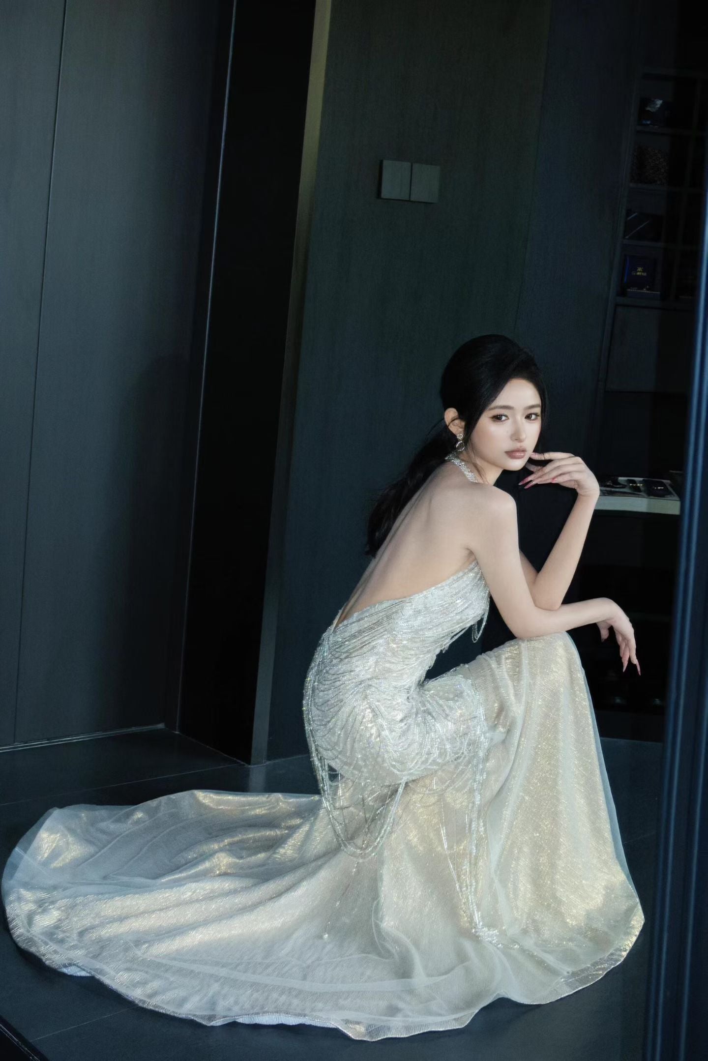 Side view of sparkling mermaid wedding dress with open back and embellished crystal detailing
