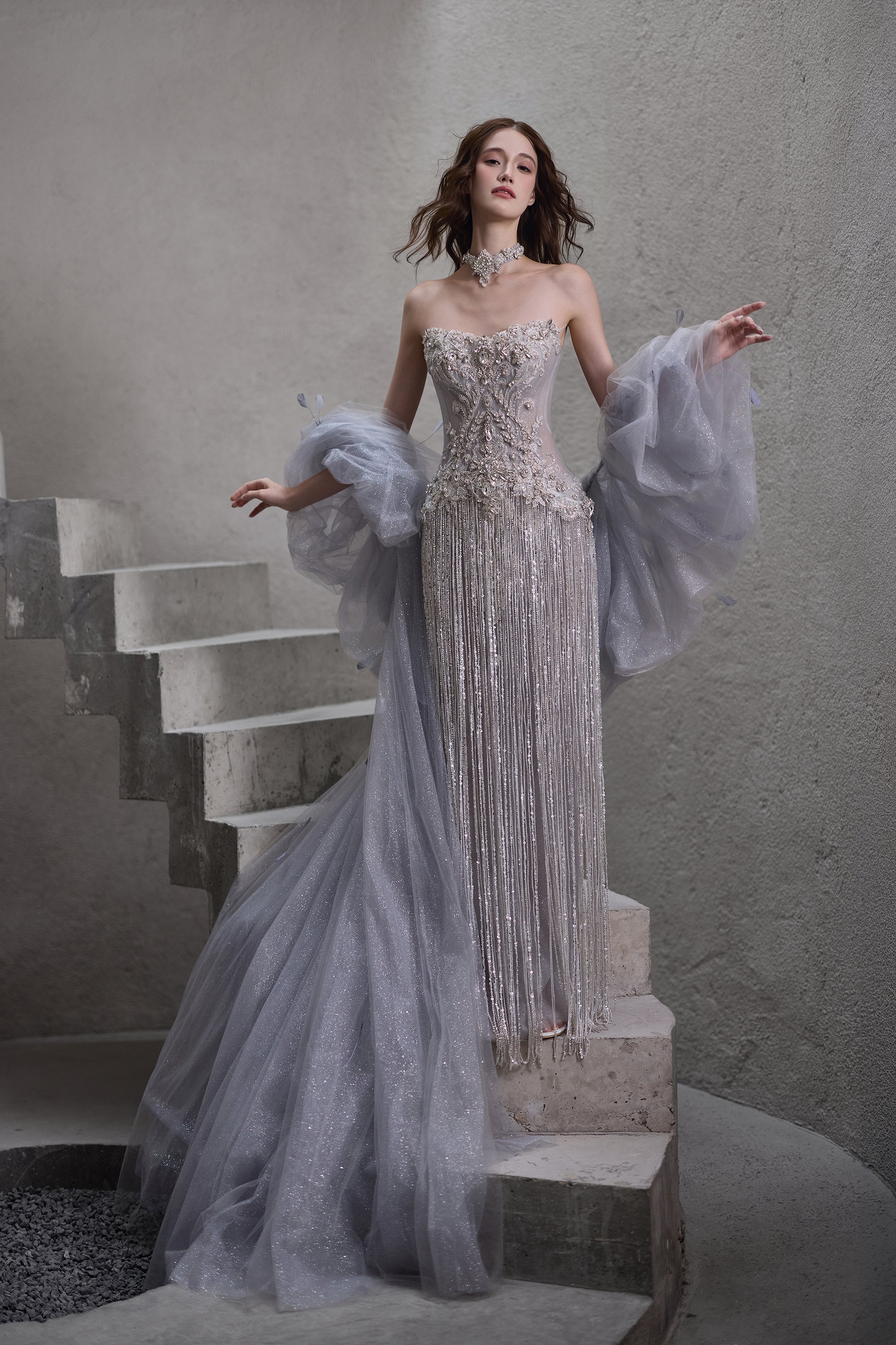 Sparkly beaded strapless wedding dress with detachable sheer sleeves and glitter train