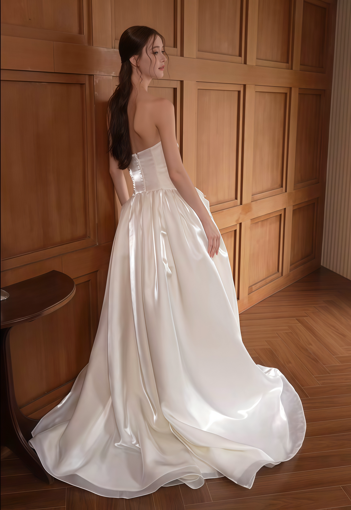 Back view of ivory satin wedding dress with button bodice, full skirt and elegant flowing train