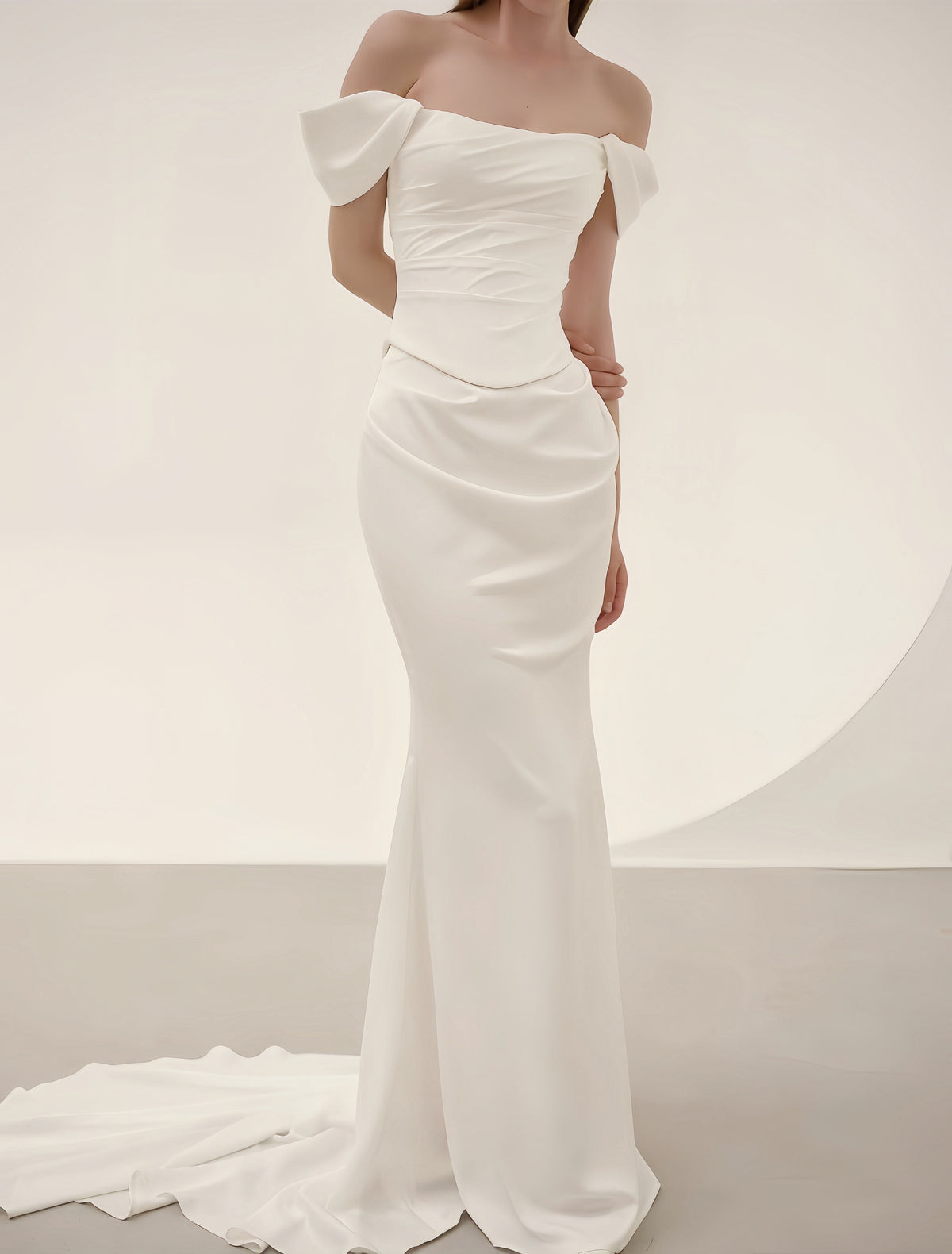 Luxury satin mermaid wedding dress with off-shoulder neckline, oversized bows, ruched bodice and elegant sweep train