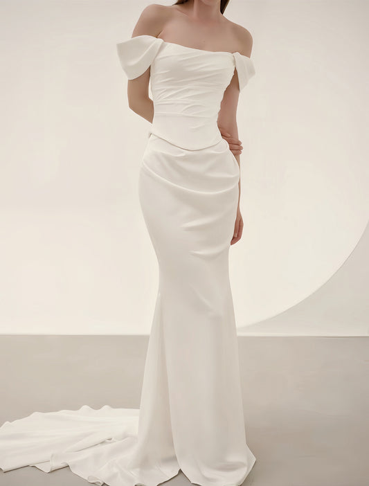 Luxury satin mermaid wedding dress with off-shoulder neckline, oversized bows, ruched bodice and elegant sweep train