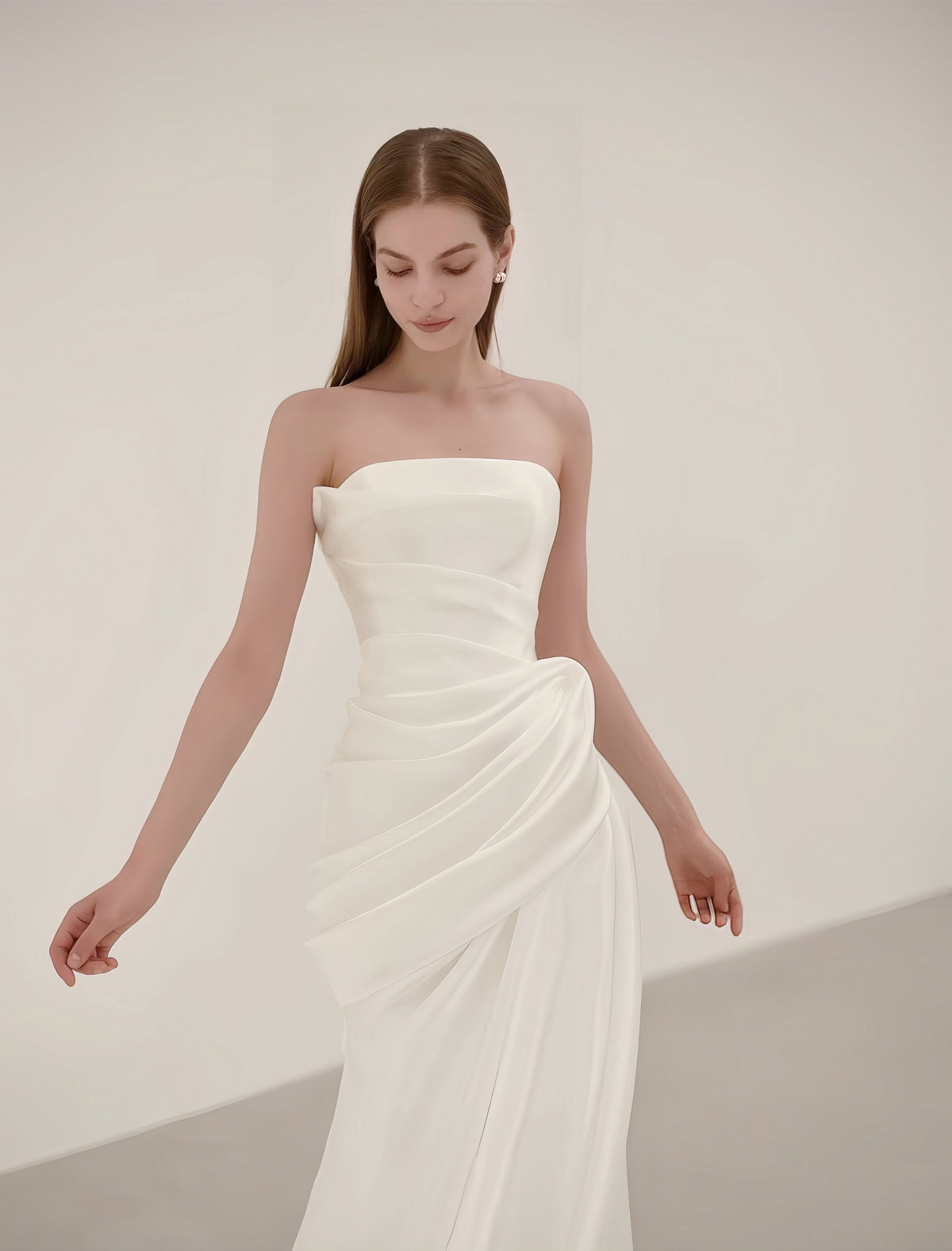 Sculptural draped satin detail on a strapless minimalist mermaid wedding dress