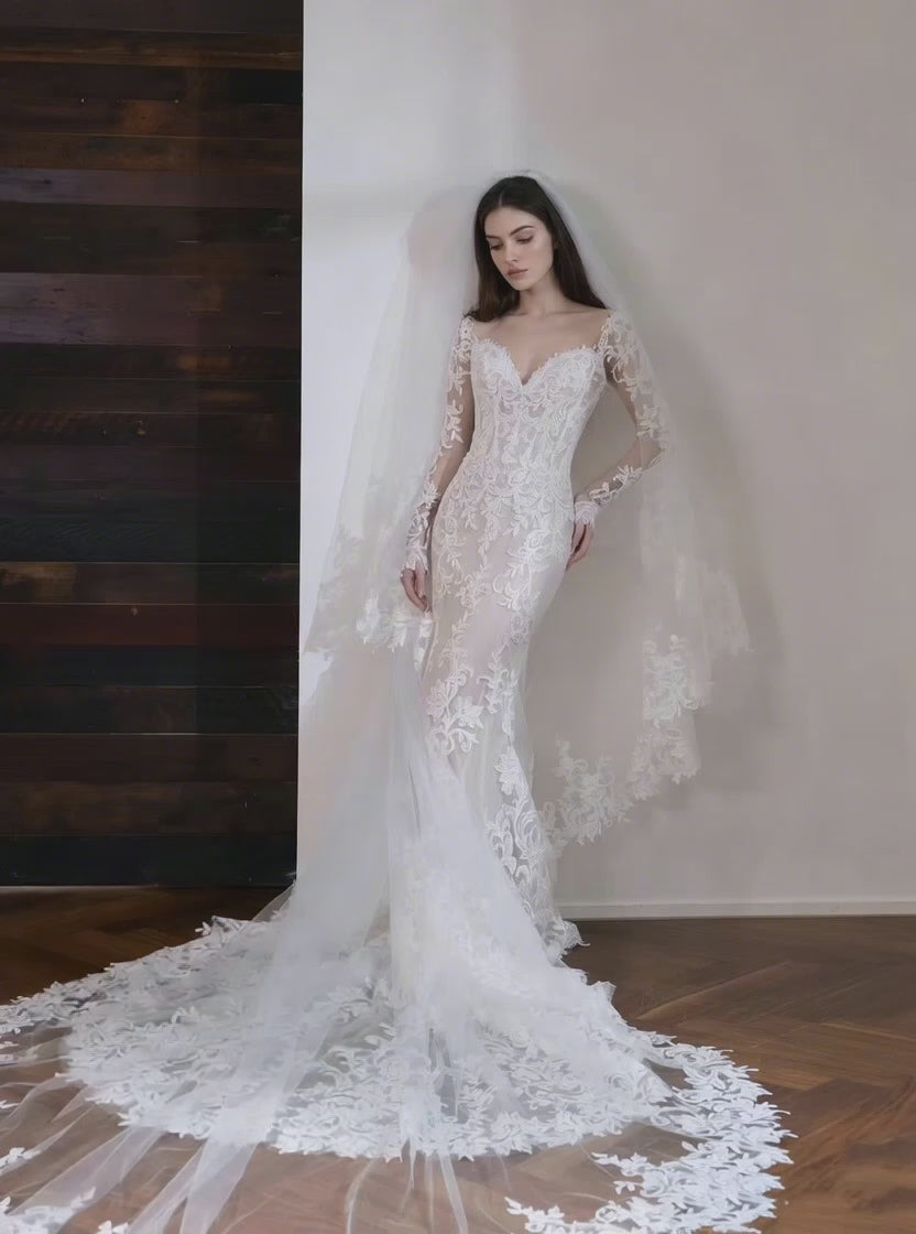 Ivory lace mermaid wedding dress with long sleeves and cathedral length train